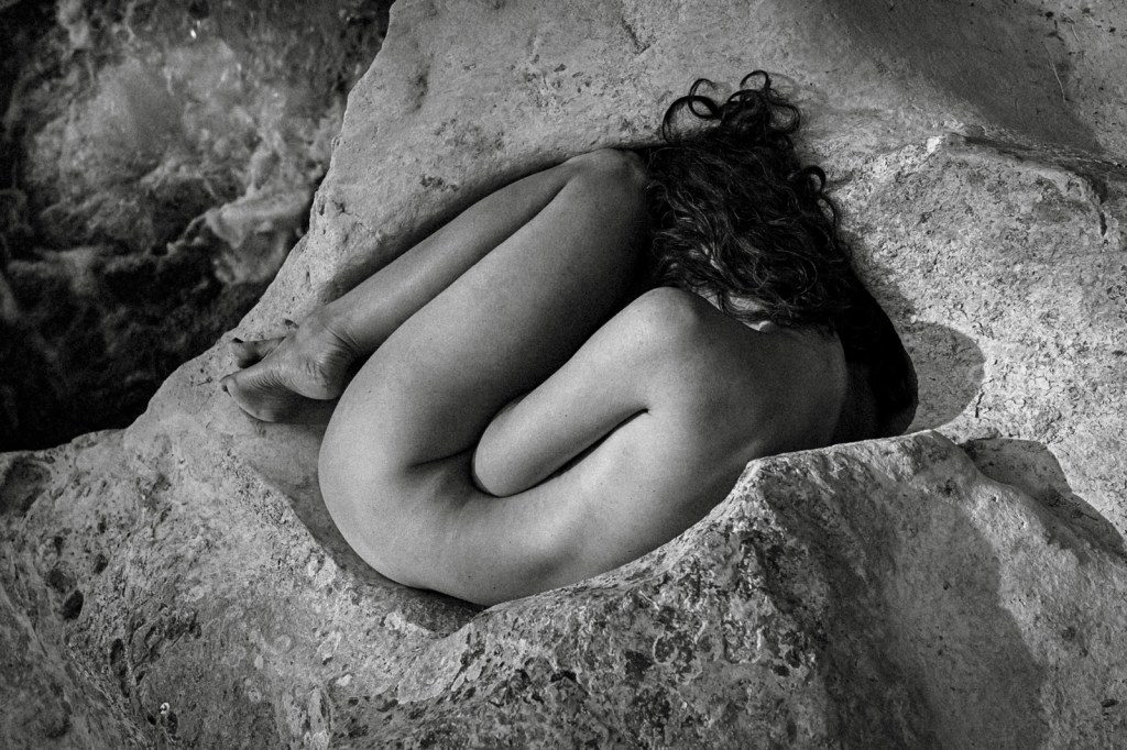 Fine art phoptography of nude female body in the whole of the rock by the river. Artist Jelena Medić on the photo made by Gjorgi Mitrevski